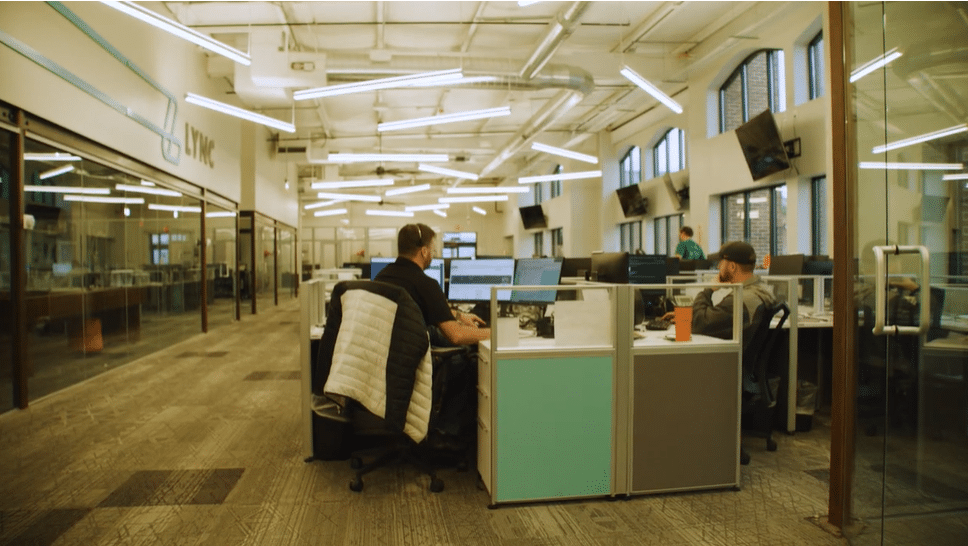 The busy office of a 3PL business with workers taking calls and managing logistics