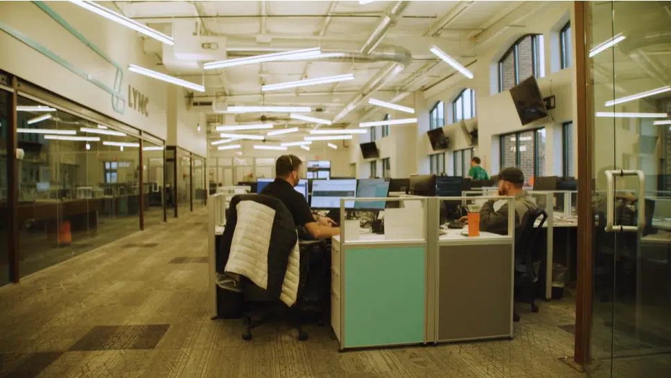 The busy office of a 3PL business with workers taking calls and managing logistics