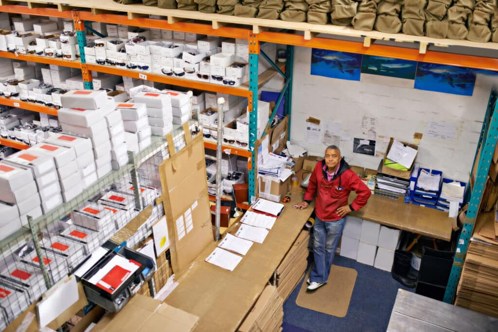 Black male owner of a technology distribution company standing in his warehouse