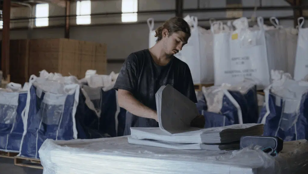 A young employee packing orders for distribution in a warehouse