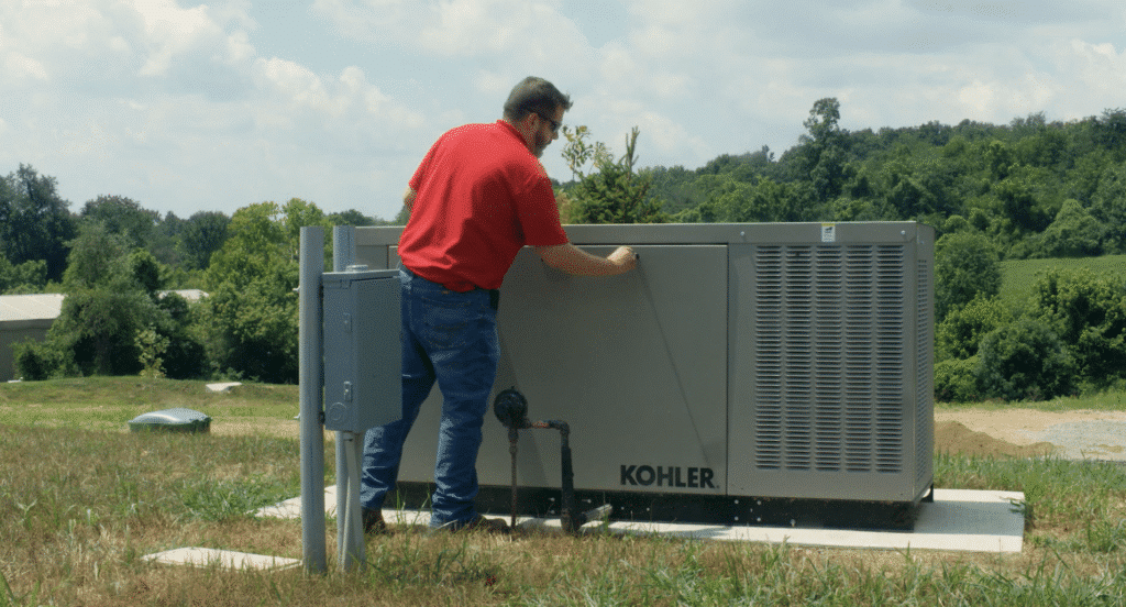 An HVAC technician serving a Kohler unit