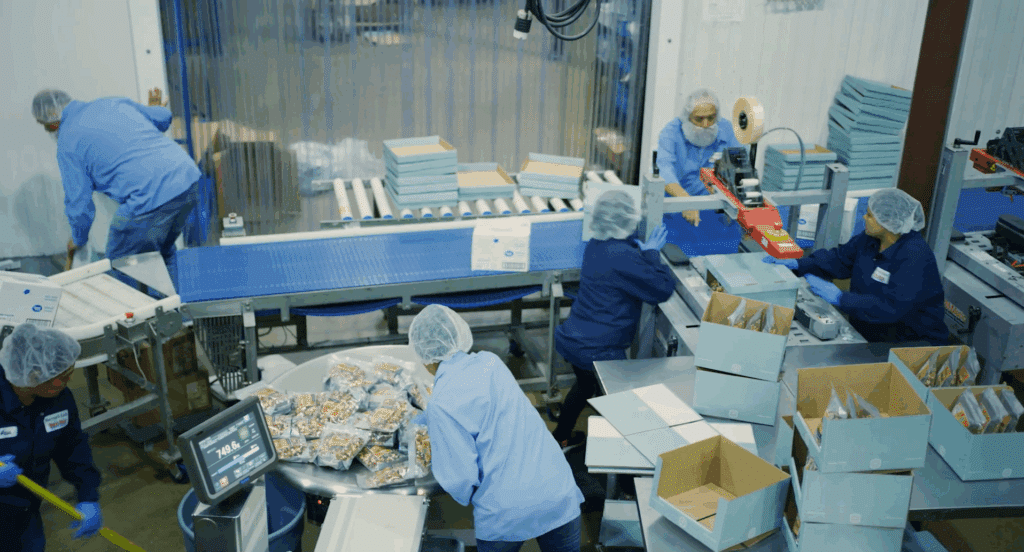 An aerial view of employees packaging orders at a snack distribution company
