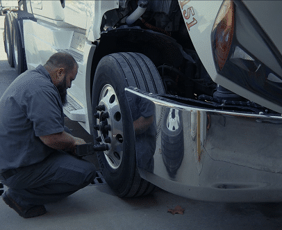 Transportation and logistics industry- mechanic fixing truck tires