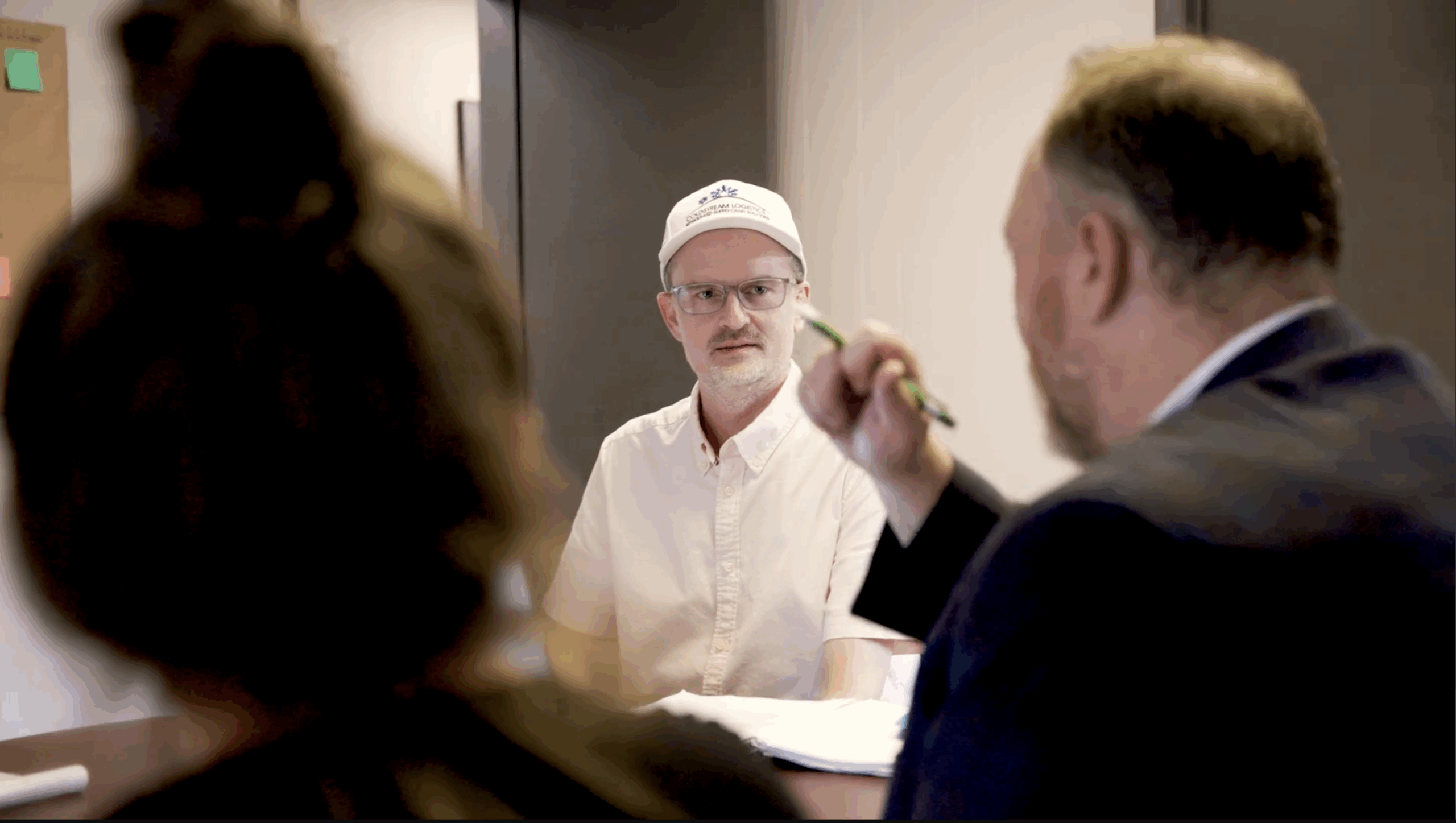 Cold Stream Logistics meeting and discussion. The owner, featured, listens intently to the conversation.