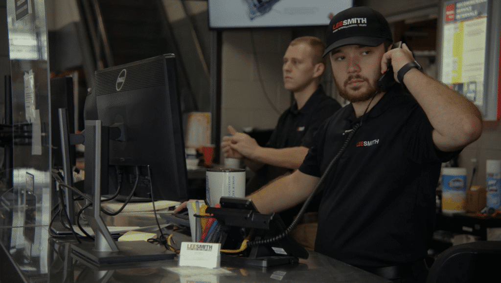 Lee-Smith Inc, Chattanooga, TN. man on the phone looking our for customers with another employee in the background.