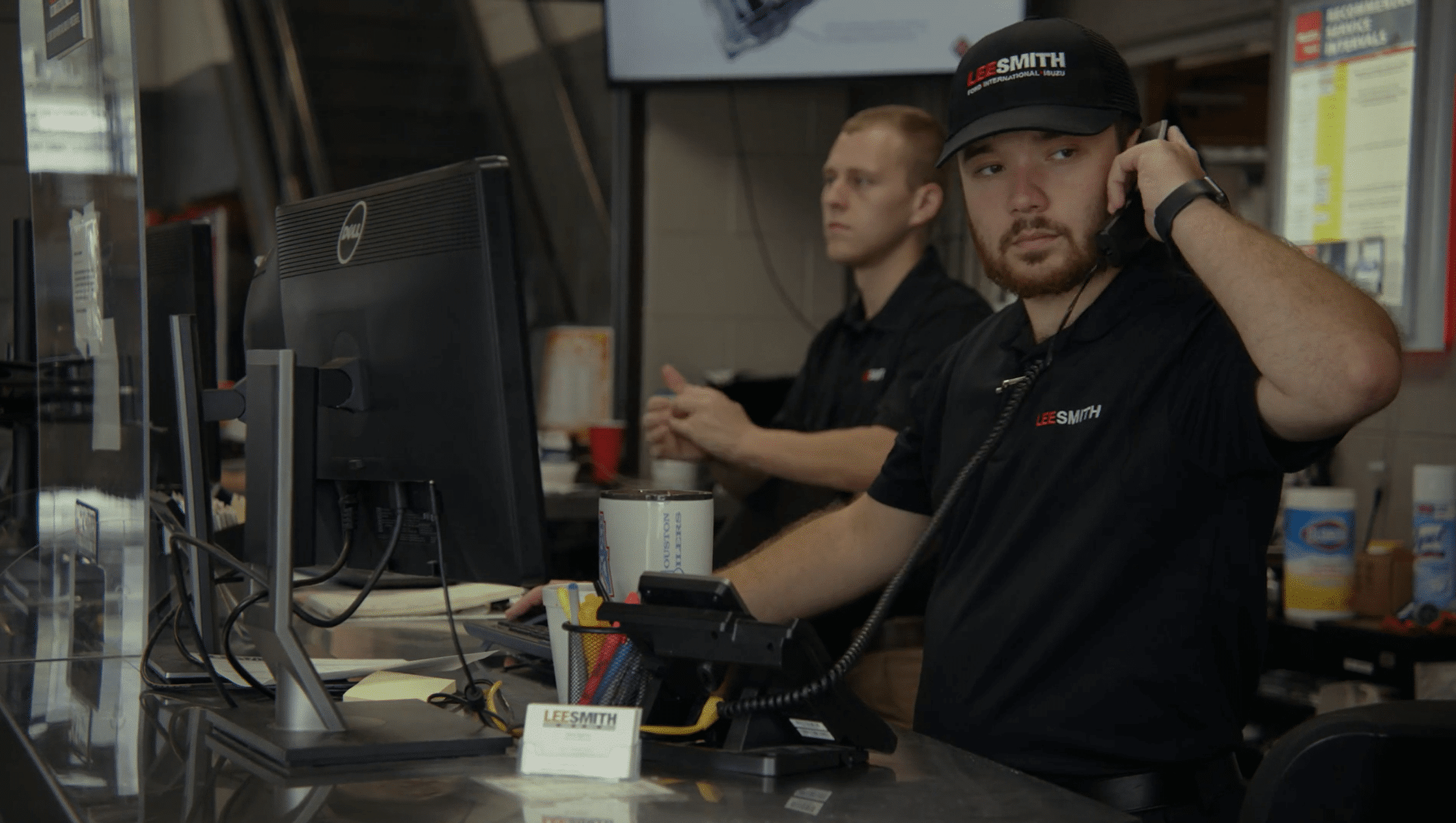 Lee-Smith Inc, Chattanooga, TN. man on the phone looking our for customers with another employee in the background.