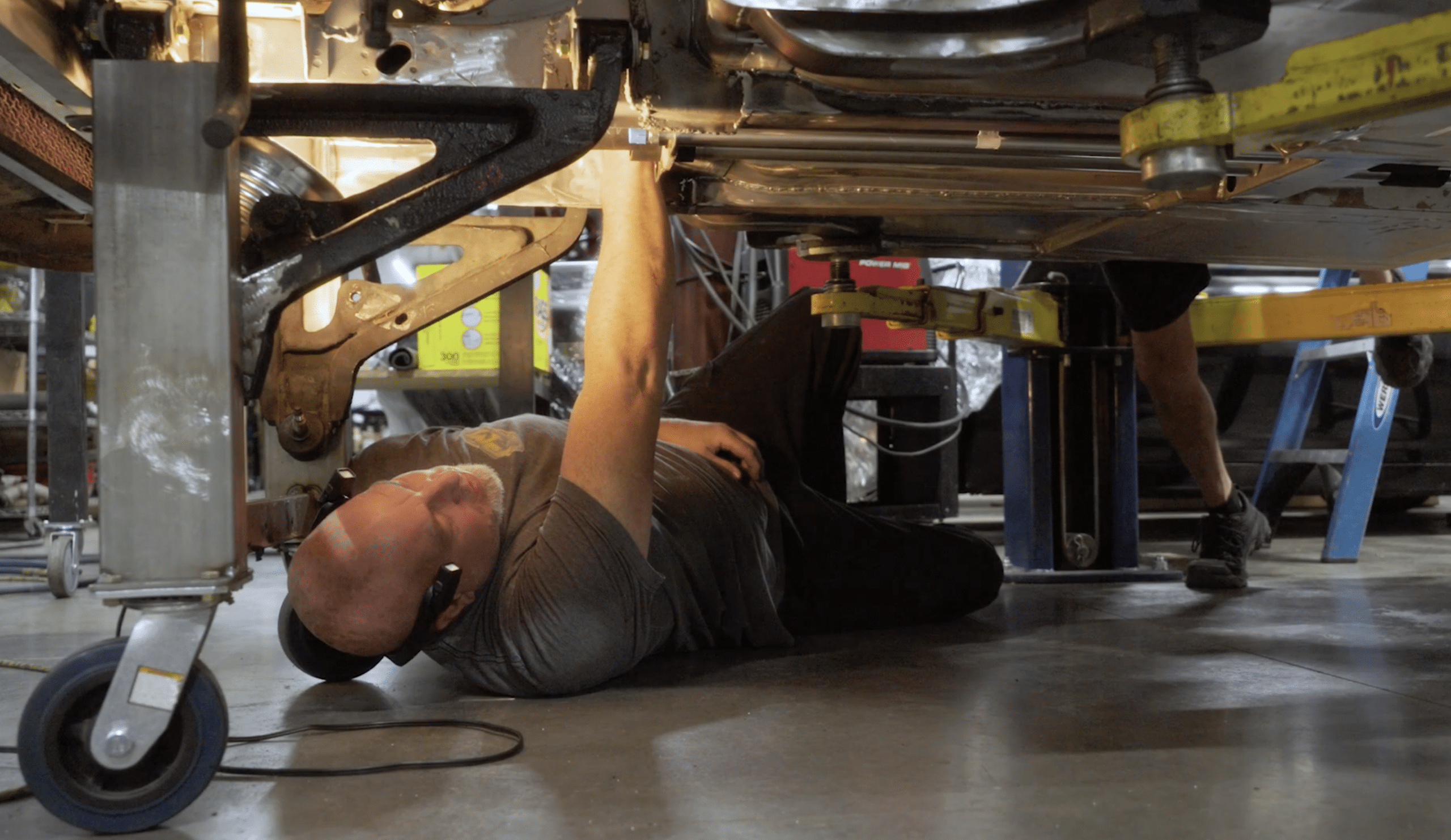 Prestige Motorsports, Concord, NC. B1 man under car doing an oil change