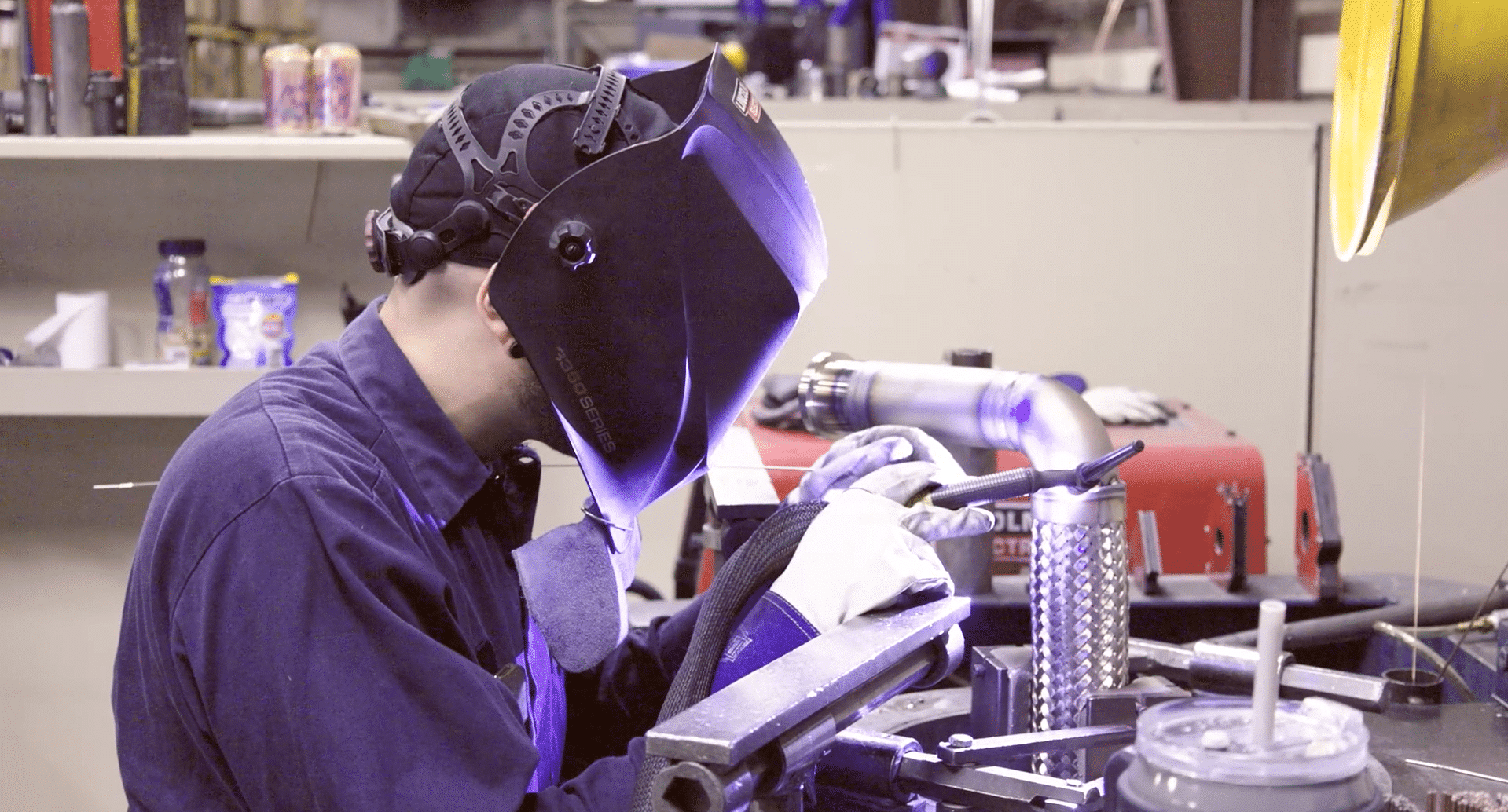 River Bend Hose Specialty. South Bend, IN. C1 welder in welding hat and torch