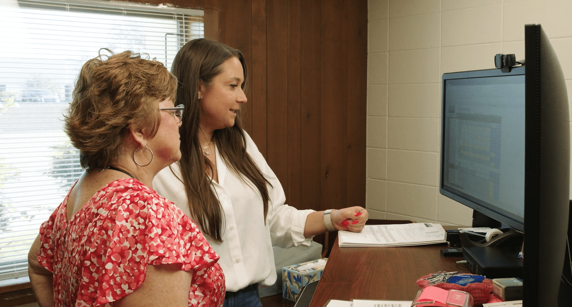 Solid Refrigeration LLC. Minneapolis, MN. A2 2 women look at computer screen reports