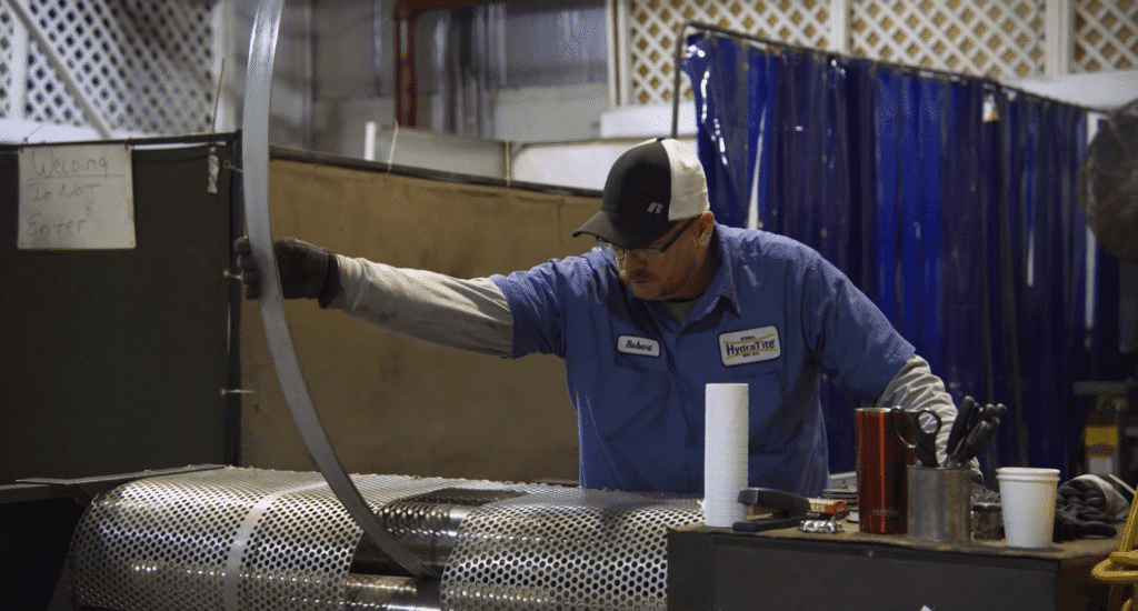 HydraTech Engineered Products LLC, based in Cincinnati, OH. B1. Trenchless Pipe and Sewer Repair Products with a man working in the facility.