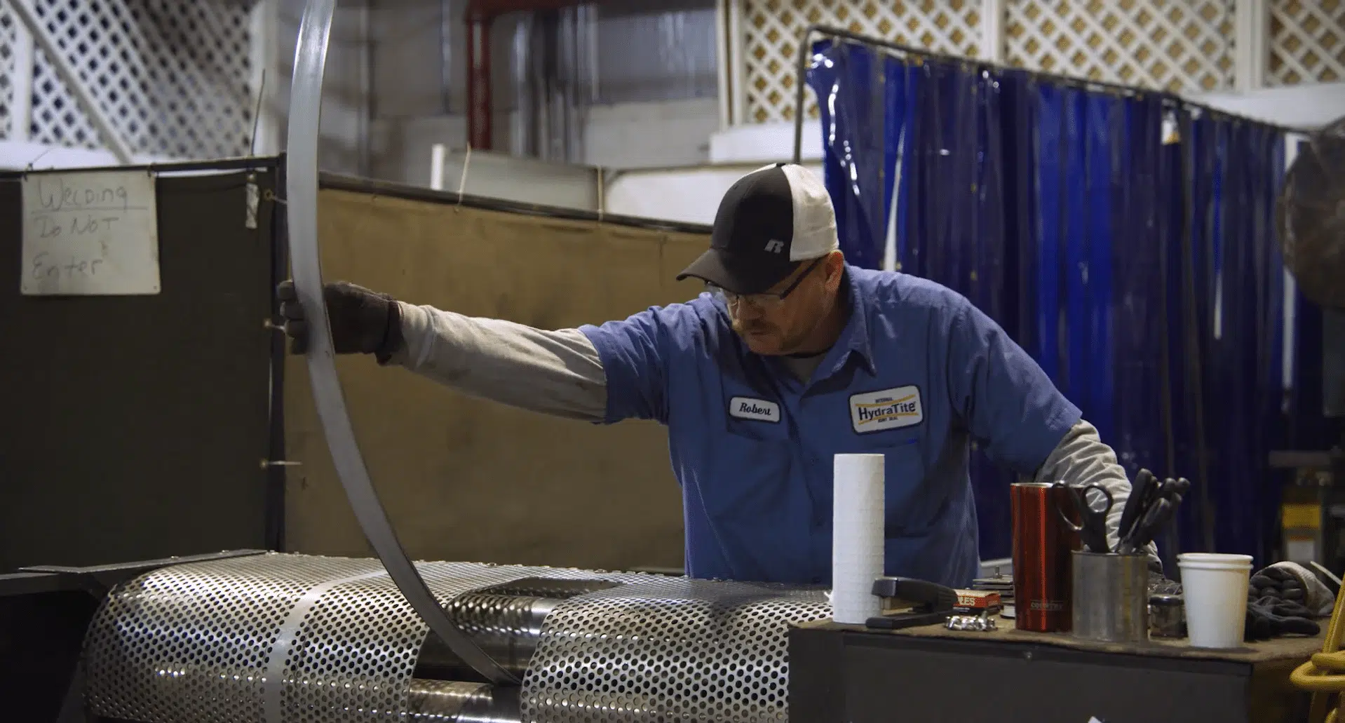 HydraTech Engineered Products LLC, based in Cincinnati, OH. B1. Trenchless Pipe and Sewer Repair Products with a man working in the facility.