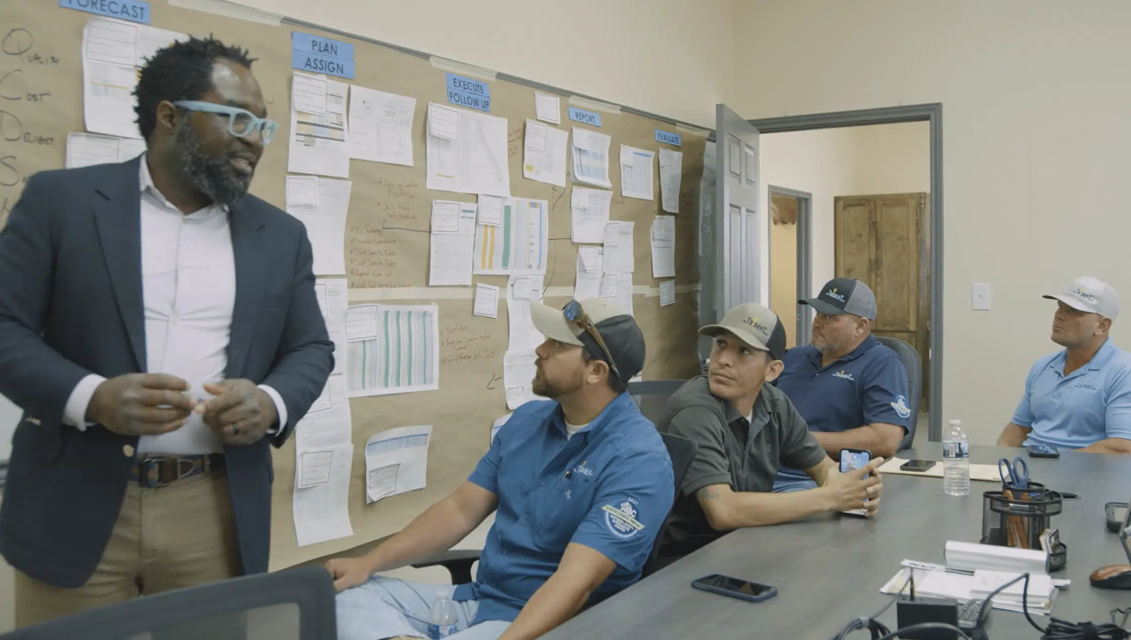 SR Trident, Inc. based in Gregory, Texas. Specializing in Industrial, Marine, and Civil Construction. Man in glasses teaching a group of 4 in the conference room. Surge Protection strategies