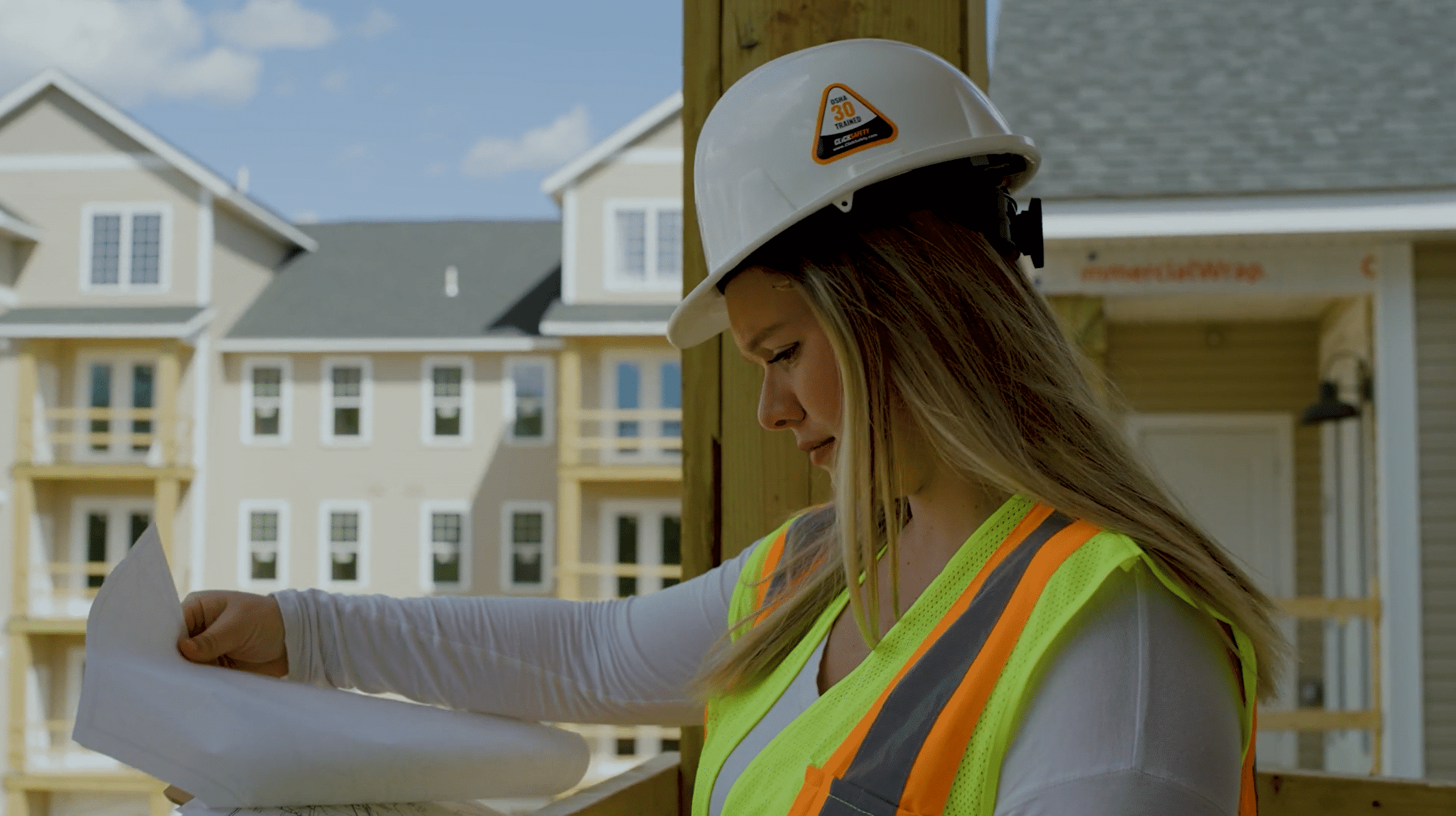 Associated Construction Company. Hartford, CT. A1 woman in hardhat looking at blueprints