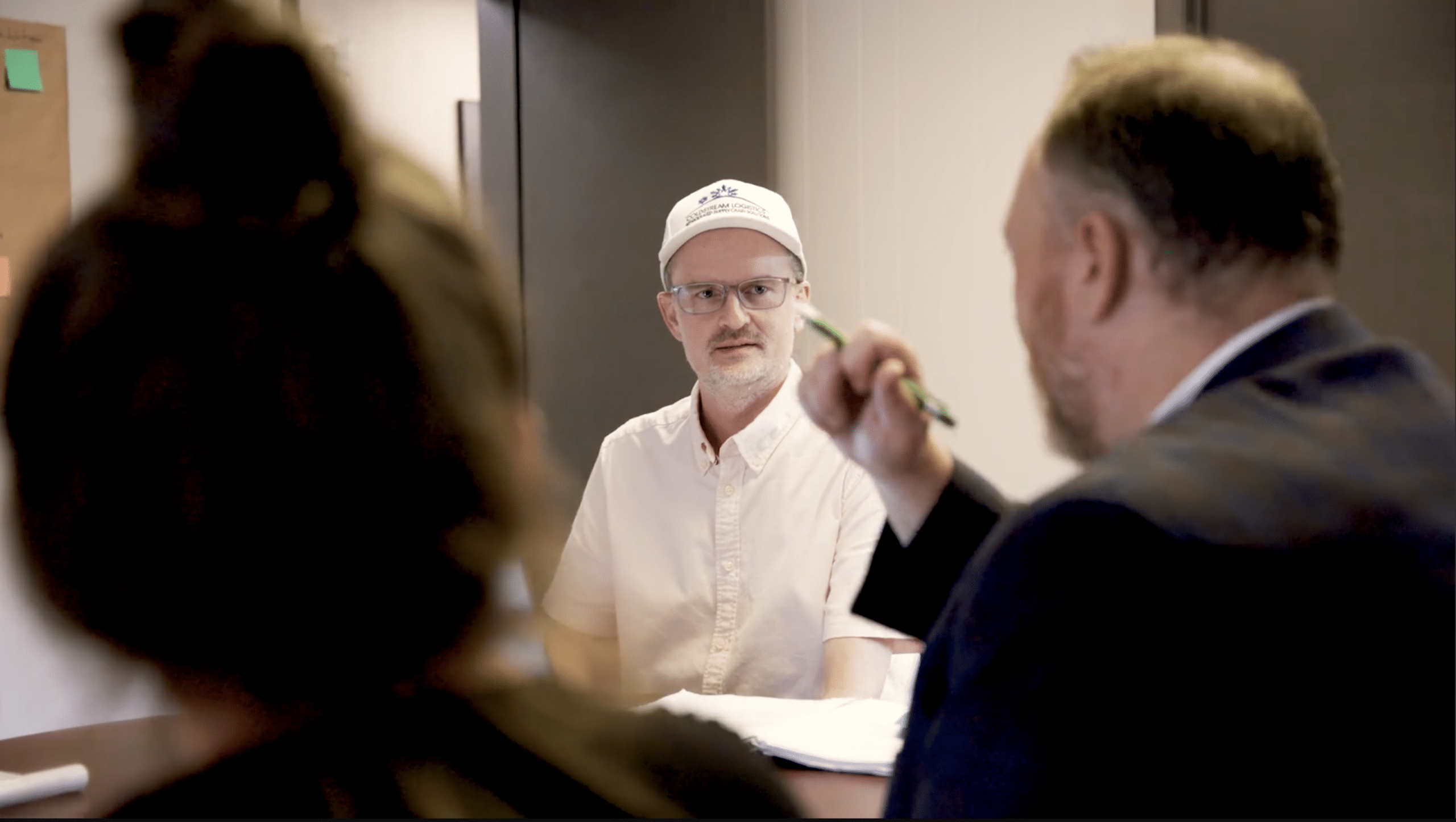Cold Stream Logistics meeting and discussion. The owner, featured, listens intently to the conversation.