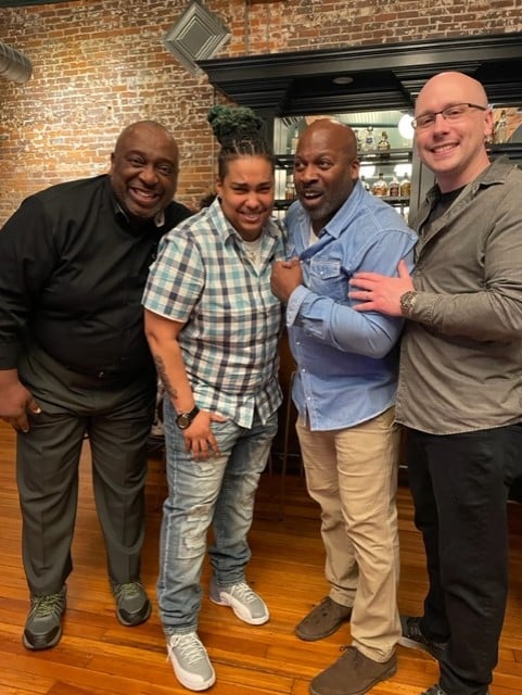 Four Cogent employees celebrating together