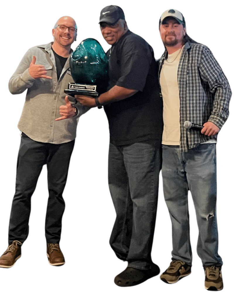 Three members of Cogent's sales team holding an award