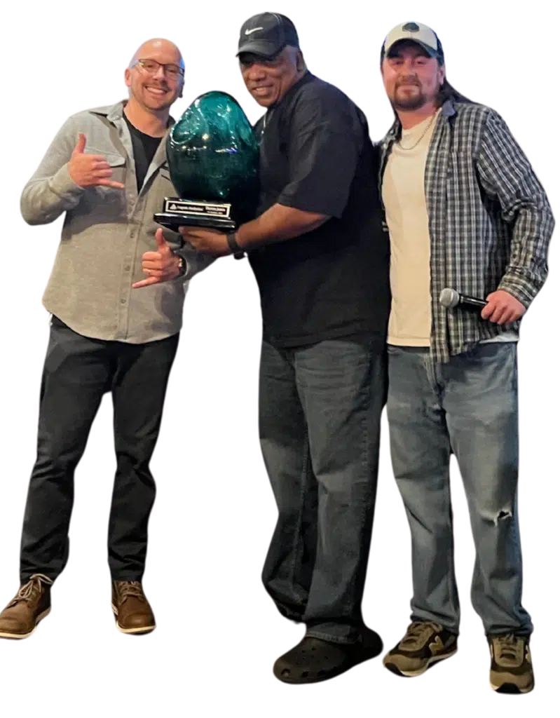Three members of Cogent's sales team holding an award