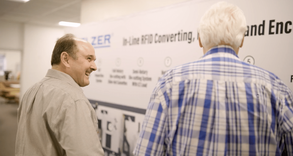Two businessmen discussing processes