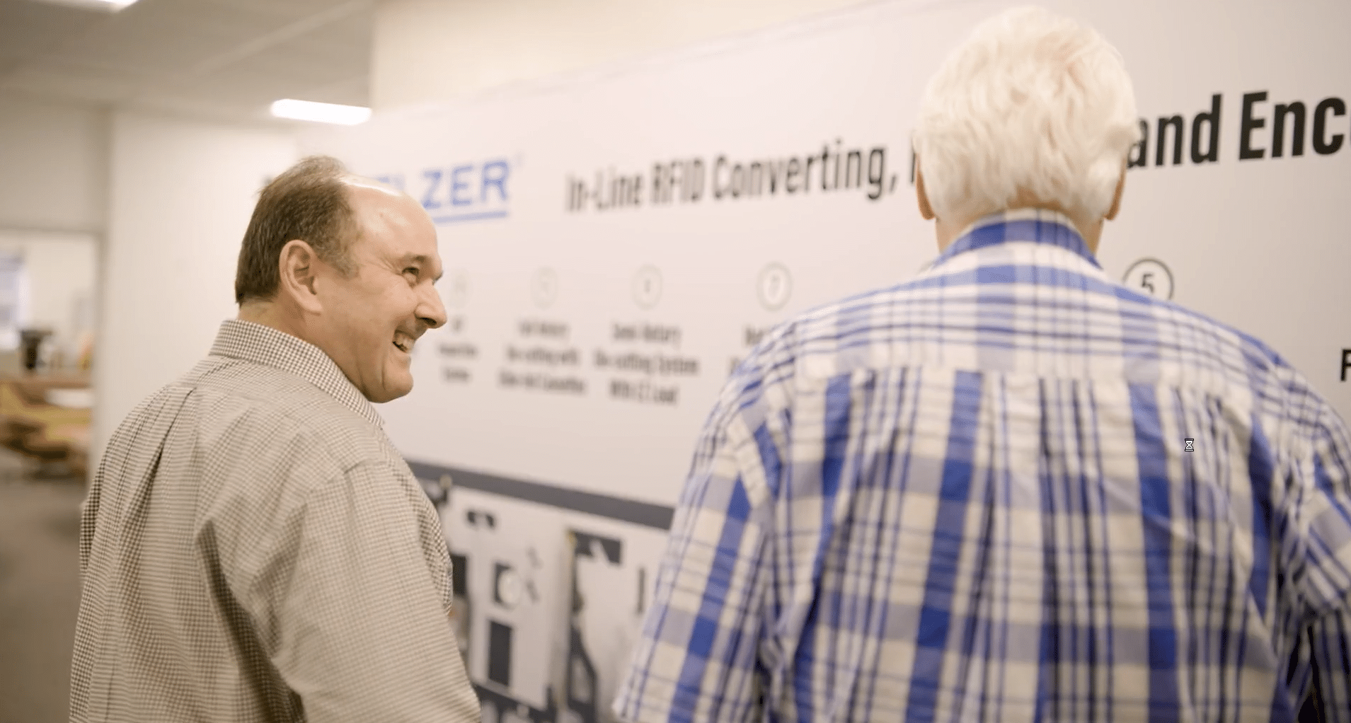 Two businessmen discussing processes