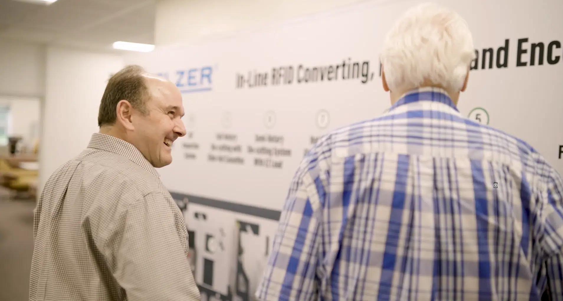 Two businessmen discussing processes
