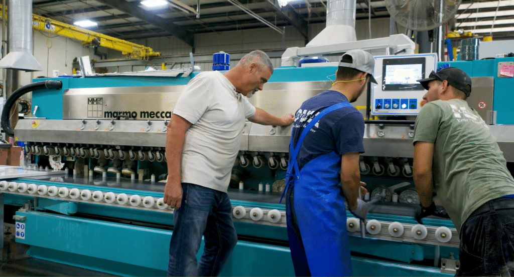 Three employees troubleshooting a manufacturing process