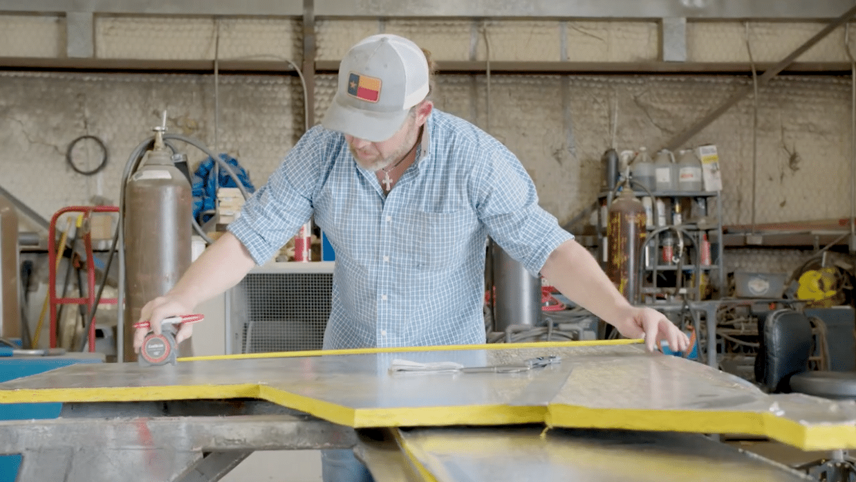 A business owner of a manufacturing company measuring materials