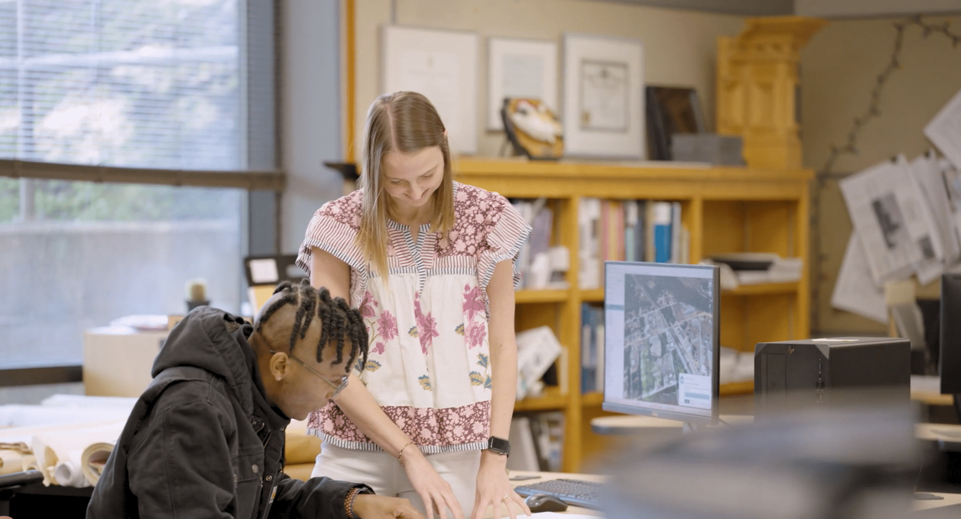 Two architects looking over sales documents in their office