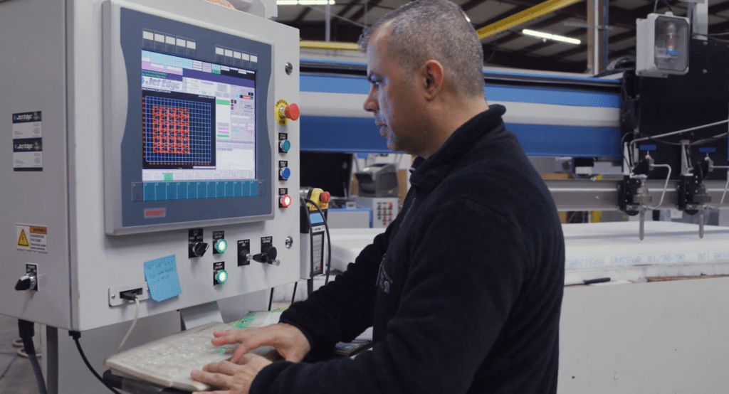A business owner working on a JetEdge machine