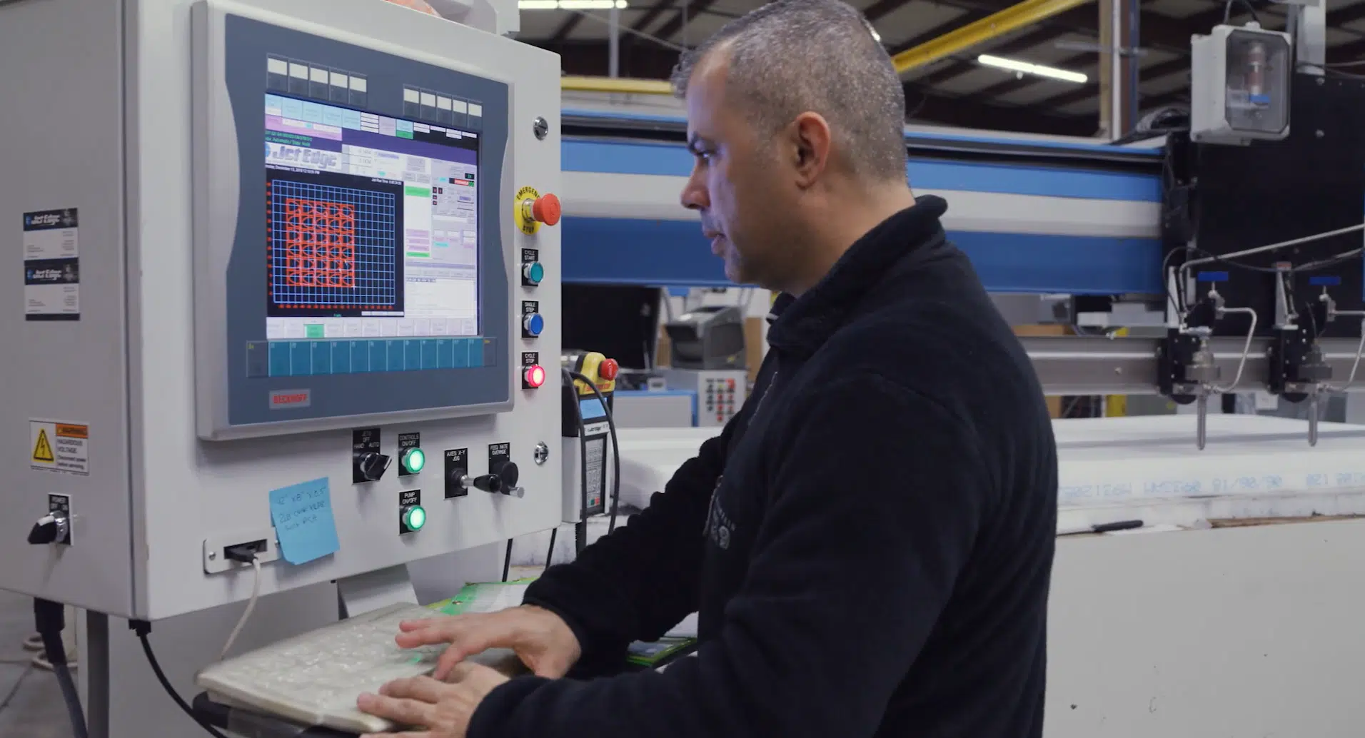 A business owner working on a JetEdge machine