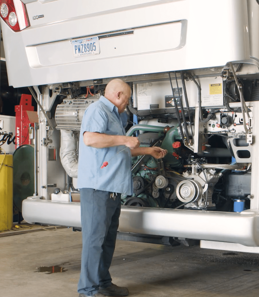 A transportation company employee checking oil.