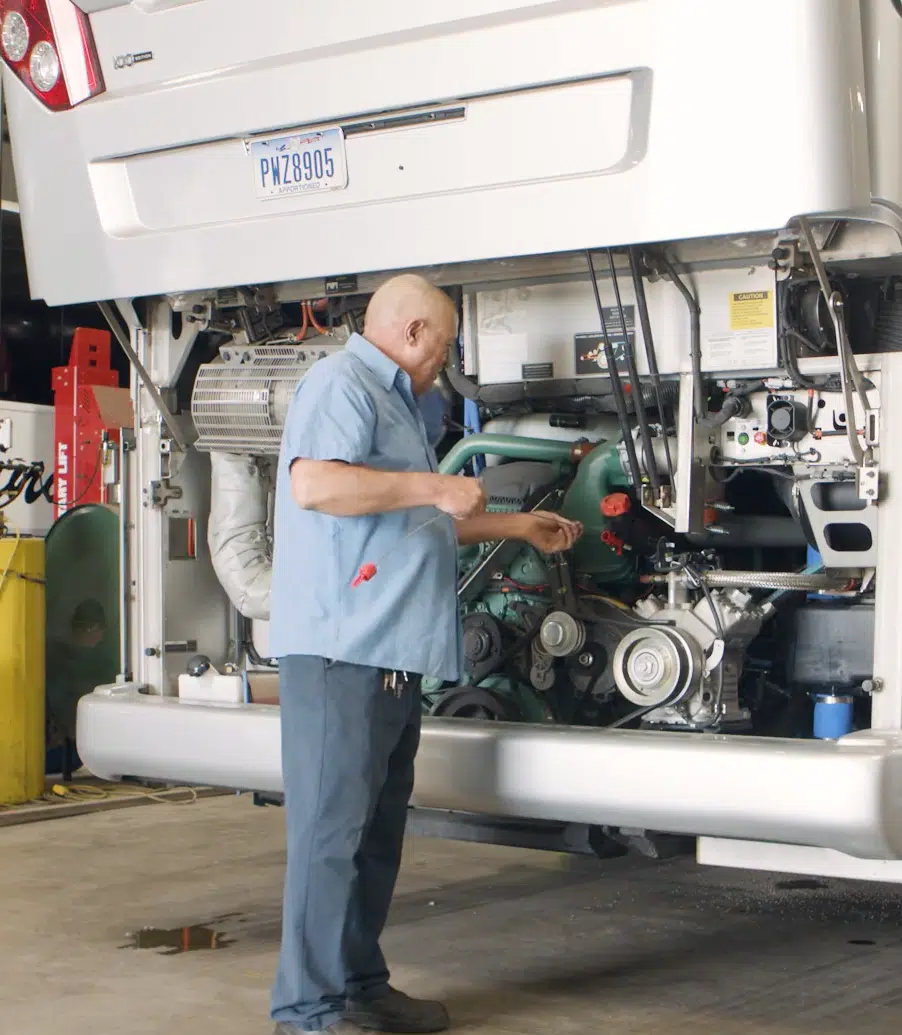 A transportation company employee checking oil.