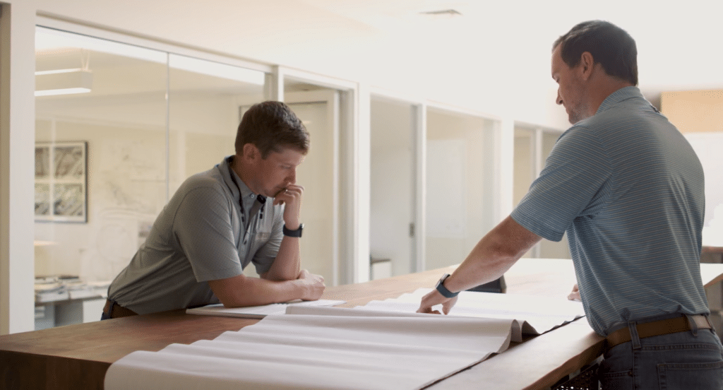 Two architects looking over project plans