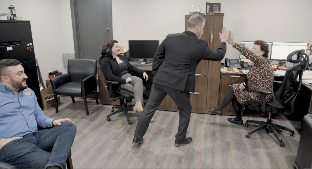 A business advisor high-fiving office members