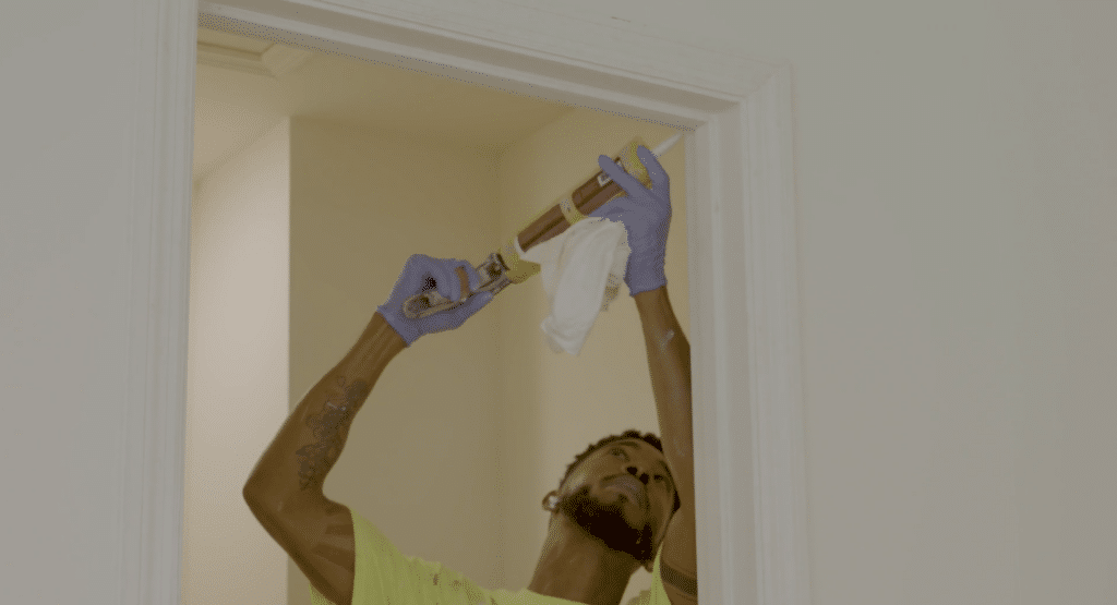 A contractor putting the finishing touches on a doorway.