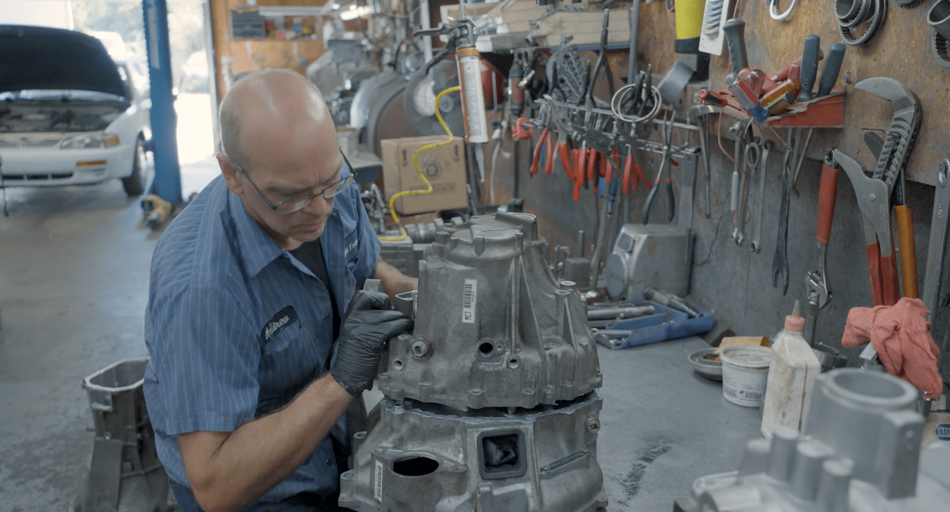 A mechanic working on a transmission