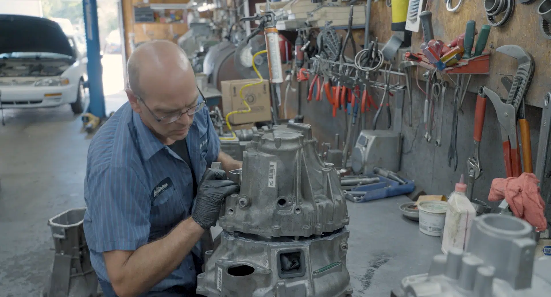 A mechanic working on a transmission