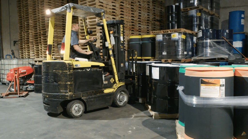 An employee using a forklift in a warehouse