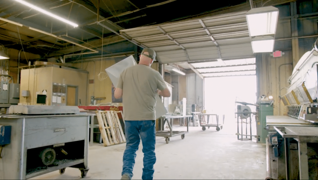 A manufacturer carrying a material on the shop floor